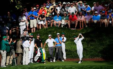 Niall Horan caddies for Rory McIlroy during the Par 3 Contest at the Masters