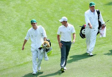 Niall Horan caddies for Rory McIlroy during the Par 3 Contest at the Masters