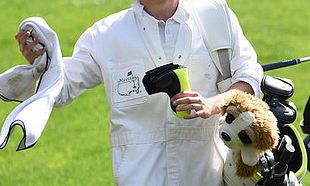 Niall Horan caddies for Rory McIlroy during the Par 3 Contest at the Masters