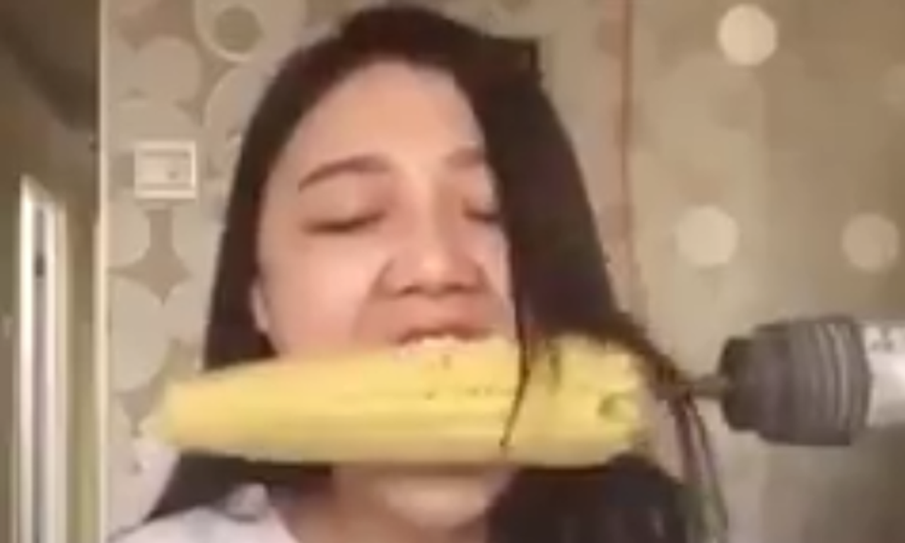 Watch Woman Tries To Eat Corn On The Cob Off A Drill And Ends Up Ripping Out Her Hair