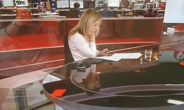 Watch BBC News Anchor gets caught scrolling through her phone on