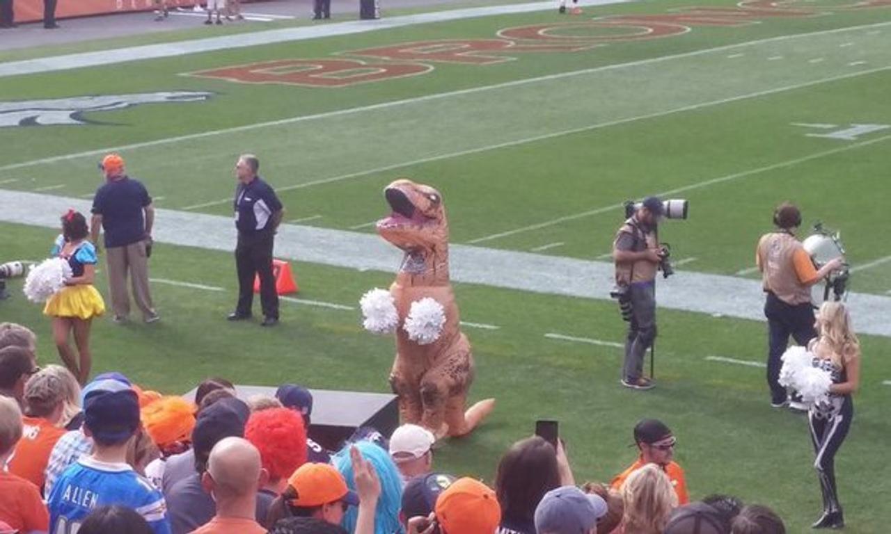 Broncos cheerleader performs in T-rex costume