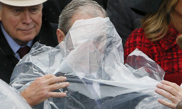 George Bush battling to put on a rain 