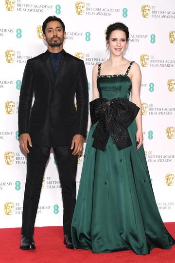 LONDON, ENGLAND - FEBRUARY 10:  Riz Ahmed (L) and Rachel Brosnahan pose in the press room during the EE British Academy Film Awards at Royal Albert Hall on February 10, 2019 in London, England. (Photo by Pascal Le Segretain/Getty Images)