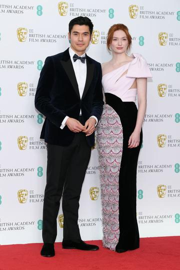 LONDON, ENGLAND - FEBRUARY 10:  Henry Golding (L) and Eleanor Tomlinson pose in the press room during the EE British Academy Film Awards at Royal Albert Hall on February 10, 2019 in London, England. (Photo by Pascal Le Segretain/Getty Images)