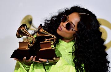 TOPSHOT - US singer Gabriella Wilson, aka H.E.R., poses with her awards for Best R&amp;B Performance "Best Part" and Best R&amp;B Album "H.E.R." in the press room during the 61st Annual Grammy Awards on February 10, 2019, in Los Angeles. (Photo by Frederic J. BROWN / AFP)        (Photo credit should read FREDERIC J. BROWN/AFP/Getty Images)