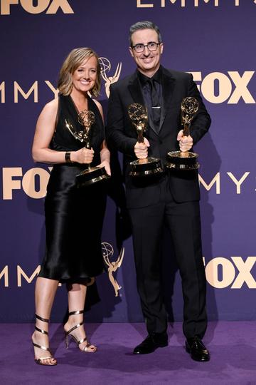 Liz Stanton (L) and John Oliver pose with awards for Outstanding Variety Talk Series in the press room during the 71st Emmy Awards at Microsoft Theater on September 22, 2019 in Los Angeles, California. (Photo by Frazer Harrison/Getty Images)