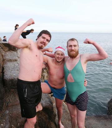 25/12/2019. Forty Foot Xmas Swim. Hundreds of people turned up at the Fortyfoot bathing spot in Sandycove, for the annual Xmas Day swim. Pictured are (LtoR) Paddy Ryan from Saggart, Philip Byrne from Loughlinstown and Robbie Dingle from Jobstown at the Forty Foot Xmas Swim. Photo:RollingNews.ie