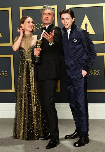 Winner of Best Adapted Screenplay for "Jojo Rabbit" New Zealand director Taika Waititi poses in the press room with US-Israeli actress Natalie Portman and US-French actor Timothee Chalamet during the 92nd Oscars at the Dolby Theater in Hollywood, California on February 9, 2020. (Photo by FREDERIC J. BROWN / AFP) (Photo by FREDERIC J. BROWN/AFP via Getty Images)