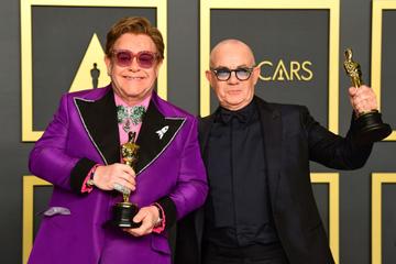 British singer-songwriter Elton John (L) and British lyricist Bernie Taupin pose in the press room with the Oscar for Best Original Song for "(I'm Gonna) Love Me Again, 'Rocketman'" during the 92nd Oscars at the Dolby Theater in Hollywood, California on February 9, 2020. (Photo by FREDERIC J. BROWN / AFP) (Photo by FREDERIC J. BROWN/AFP via Getty Images)