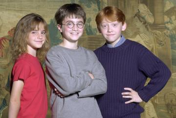 Warner Bros. Pictures announced August 21, 2000 that the young actor Daniel Radcliffe, center, has been named as the young actor who will play Harry Potter, in the upcoming film adaptation of the popular books by J.K. Rowling. Newcomers Rupert Grint, right, and Emma Watson will be taking on the roles of Ron and Hermione, Harry's best friends at Hogwarts. (Courtesy of Warner Bros./Newsmakers)