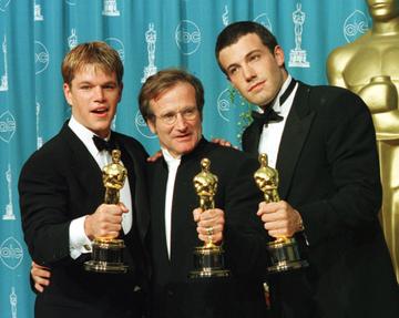 1998: Actors-writers Matt Damon (L) and Ben Affleck (R) pose with actor Robin Williams with their Oscars they won for "Good Will Hunting" at the 70th Annual Academy Awards 23 March in Los Angeles.  Damon and Affleck won Best Original Screenplay and Williams won for Best Supporting Actor.  (Photo credit should read HAL GARB/AFP via Getty Images)