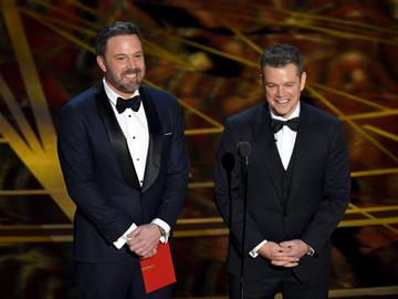 2017:  Actor/director Ben Affleck (L) and actor/producer Matt Damon speak onstage during the 89th Annual Academy Awards at Hollywood &amp; Highland Center on February 26, 2017 in Hollywood, California.  (Photo by Kevin Winter/Getty Images)