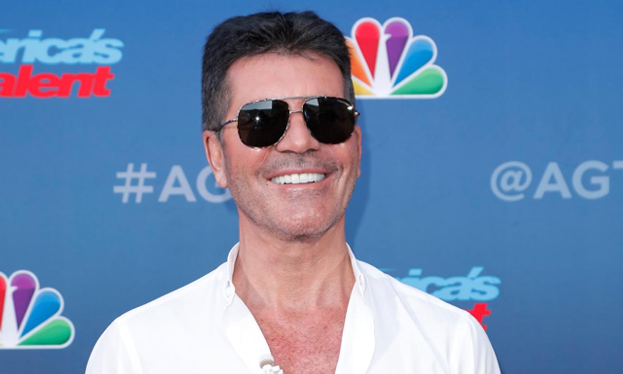 Simon Cowell in hospital having broken his back in a bike accident
