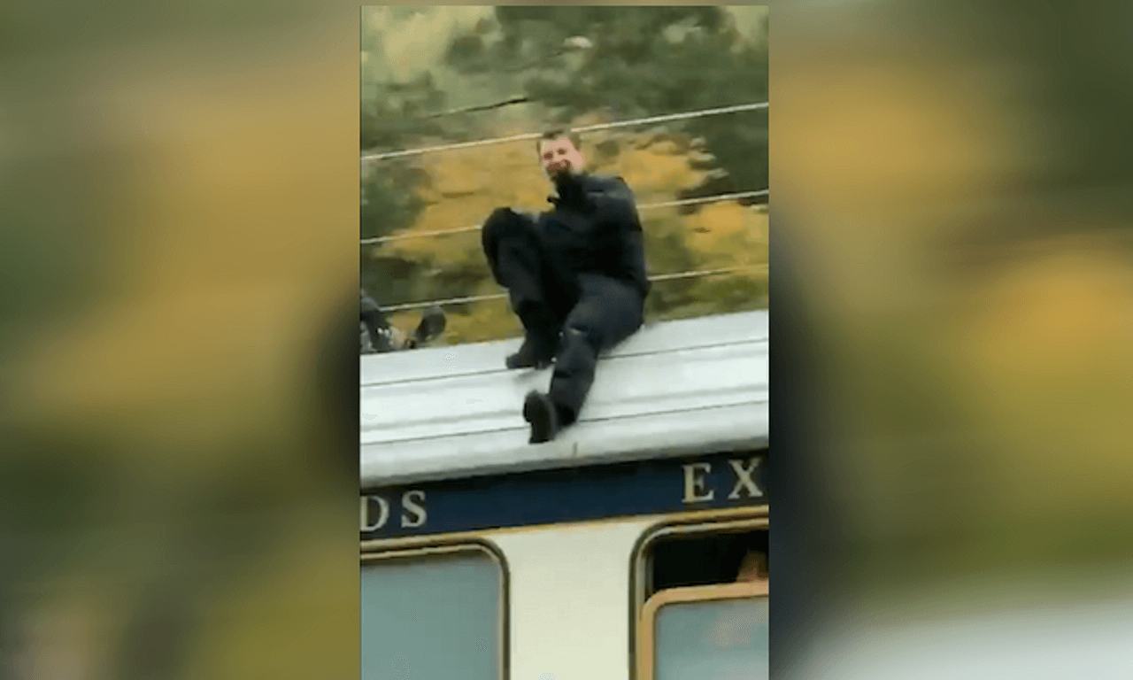 Tom Riding A Train Here's Tom Cruise waving calmly at people on top of a speeding train