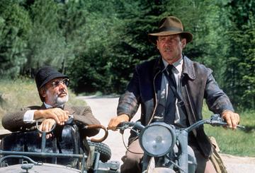 American actor Harrison Ford as the eponymous archaeologist and Scottish actor Sean Connery as his father Henry Jones during the motorcycle chase scene from the film 'Indiana Jones and the Last Crusade', 1989.  (Photo by Murray Close/Getty Images)