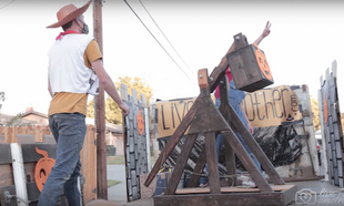 Guy builds functional trebuchet for handing out sweets to keep social distance