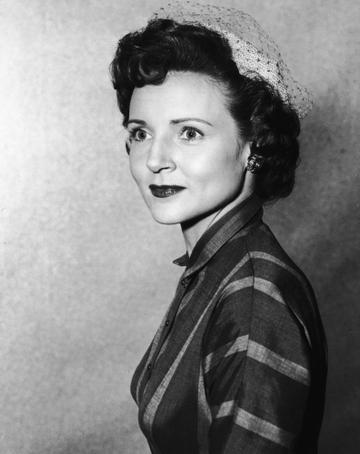 A headshot portrait of American actor Betty White wearing a veiled hat, circa 1955. (Photo by Hulton Archive/Getty Images)