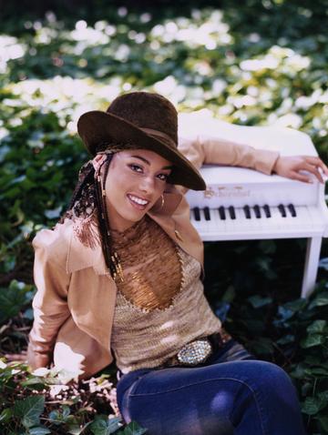 Alicia Keys poses for a promotional picture in the early 2000's (Photo by Deborah Feingold/Corbis via Getty Images)