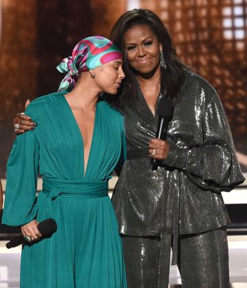 2019:  Alicia Keys (L) and Michelle Obama speak during the 61st Annual GRAMMY Awards at Staples Center on February 10, 2019 in Los Angeles, California.  (Photo by Kevin Winter/Getty Images for The Recording Academy)