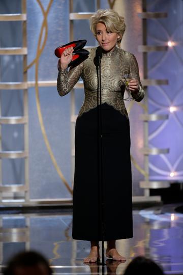 Presenter Emma Thompson arrives onstage during the 71st Annual Golden Globe Awards with her shoes and a martini in hand.

(Photo by Paul Drinkwater/NBCUniversal via Getty Images)