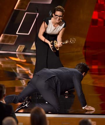 Actor Jon Hamm decided to crawl onstage to accept Outstanding Lead Actor in a Drama Series award for 'Mad Men' from actress Tina Fey onstage during the 67th Annual Primetime Emmy Awards.  

(Photo by Kevin Winter/Getty Images)