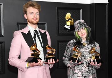 (L-R) FINNEAS and Billie Eilish, winners of Record of the Year for 'Everything I Wanted' and Best Song Written For Visual Media for "No Time To Die", pose in the media room during the 63rd Annual GRAMMY Awards at Los Angeles Convention Center on March 14, 2021 in Los Angeles, California. (Photo by Kevin Mazur/Getty Images for The Recording Academy )