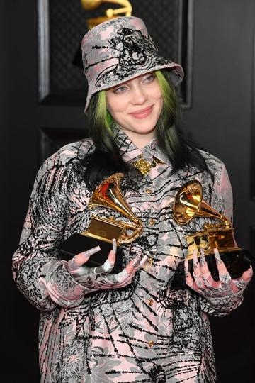 Billie Eilish, winner of the Record of the Year award for 'Everything I Wanted' and the Best Song Written for Visual Media award for ‘No Time to Die,’ poses in the media room during the 63rd Annual GRAMMY Awards at Los Angeles Convention Center on March 14, 2021 in Los Angeles, California. (Photo by Kevin Mazur/Getty Images for The Recording Academy )