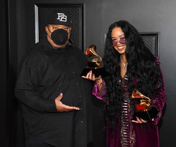 (L-R) Jeff Robinson and H.E.R., winners of Song of the Year for "I Can't Breathe", pose in the media room during the 63rd Annual GRAMMY Awards at Los Angeles Convention Center on March 14, 2021 in Los Angeles, California. (Photo by Kevin Mazur/Getty Images for The Recording Academy )