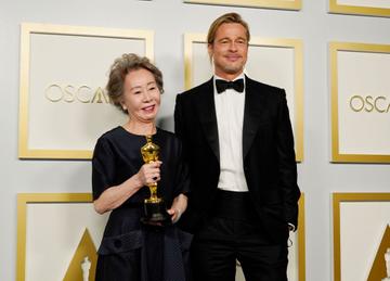 Yuh-Jung Youn, winner of Best Actress in a Supporting Role for "Minari," poses with Brad Pitt in the press room at the Oscars on Sunday, April 25, 2021, at Union Station in Los Angeles. (Photo by Chris Pizzello-Pool/Getty Images)