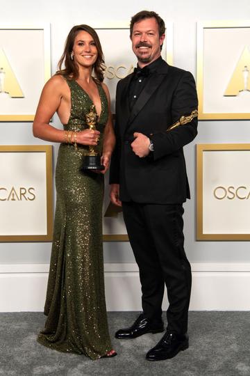 Pippa Erlich and James Reed pose backstage with the Oscar for Documentary Feature for "My Octopus Teacher" in the press room during the 93rd Annual Academy Awards at Union Station on April 25, 2021 in Los Angeles, California. (Photo by Matt Petit/A.M.P.A.S. via Getty Images)