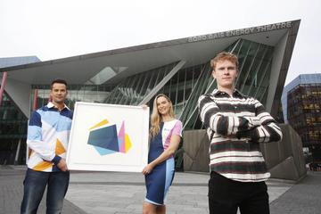 Bord Gáis Energy today unveiled the new designs created by Luke Reidy and inspired by the dynamic, angular shape of the theatre, which will feature across ambassador uniforms, customer merchandise and other in-theatre collateral.  Pictured alongside Luke are models Sarah Morrissey and Darren Regazzoli wearing the new uniform design. Photo: Leon Farrell/Photocall Ireland.