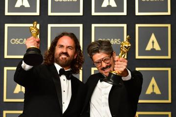 Spanish director and animator Alberto Mielgo (R) and Spanish producer Leo Sanchez (L) are all smiles with their award for Best Animated Short Film for "The Windshield Wiper"in the press room during the 94th Oscars at the Dolby Theatre in Hollywood, California on March 27, 2022. (Photo by Frederic J. Brown / AFP) (Photo by FREDERIC J. BROWN/AFP via Getty Images)